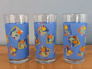 Small tumblers with framed multicolor abstract tulips in a blue background, set of 3