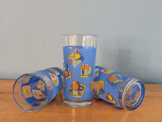 Small tumblers with framed multicolor abstract tulips in a blue background, set of 3