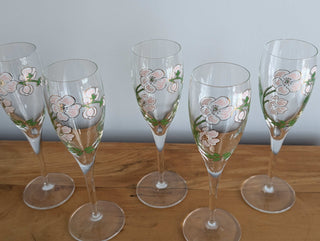 Crystal champagne stemware with soft pink florals, light green leaves, and gold lustre, set of 5