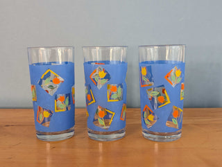 Small tumblers with framed multicolor abstract tulips in a blue background, set of 3