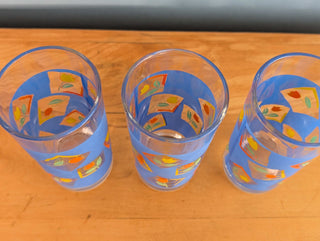 Small tumblers with framed multicolor abstract tulips in a blue background, set of 3