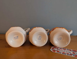 Trio of artisanal ceramic mugs, footed, autumn colors, leafy silhouette decals