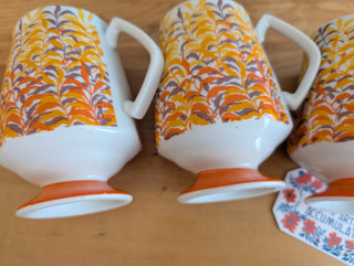 Trio of artisanal ceramic mugs, footed, autumn colors, leafy silhouette decals
