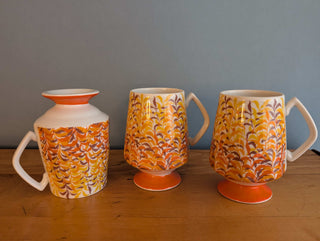 Trio of artisanal ceramic mugs, footed, autumn colors, leafy silhouette decals