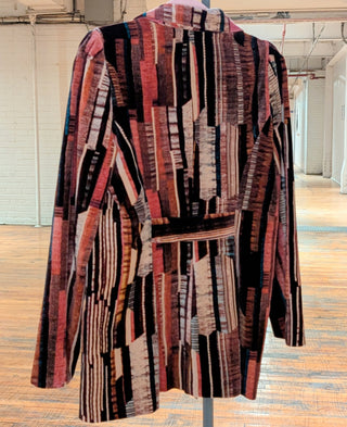 Blazer vintage en velours à motifs, orange et marron, avec nœud sur le devant.