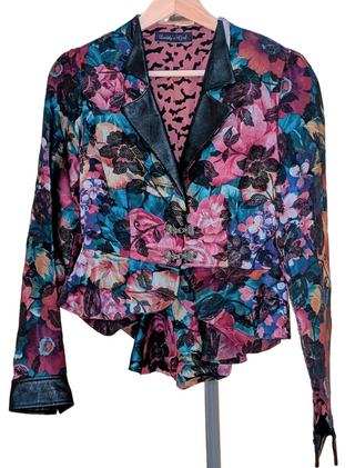 Dark botanical cropped blazer with unique closure and coattails, lined with pink fabric, leather collar