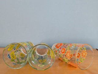 Trio of medium-sized tumblers with orange and green floral patterns - Artful Accumulator Boutique Vintage