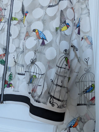 white tulle mesh with circles, zip up see through cardigan with colorful flying birds and bird cages