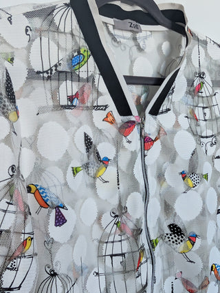 white tulle mesh with circles, zip up see through cardigan with colorful flying birds and bird cages