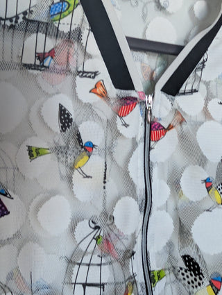 white tulle mesh with circles, zip up see through cardigan with colorful flying birds and bird cages