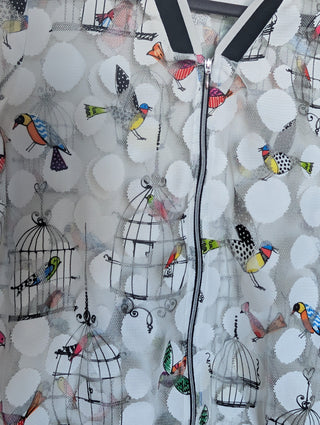 white tulle mesh with circles, zip up see through cardigan with colorful flying birds and bird cages