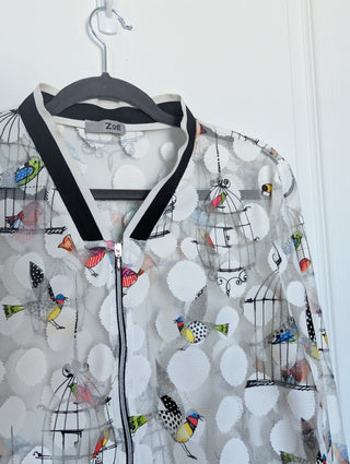 white tulle mesh with circles, zip up see through cardigan with colorful flying birds and bird cages