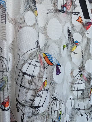 white tulle mesh with circles, zip up see through cardigan with colorful flying birds and bird cages