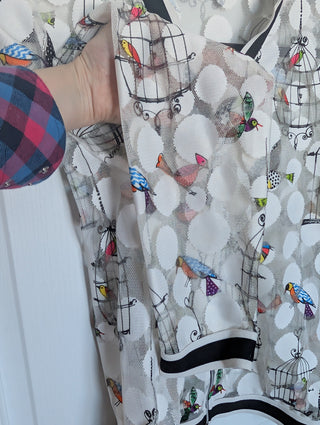 white tulle mesh with circles, zip up see through cardigan with colorful flying birds and bird cages